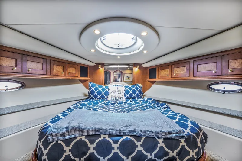 Slide: The Image of Luxurious cabin interior of 2003 Cruisers 5470 Express yacht with cozy bedding. - 48