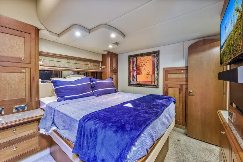 Slide: The Image of Luxurious bedroom interior of 2003 Cruisers 5470 Express yacht with cozy bedding. - 42
