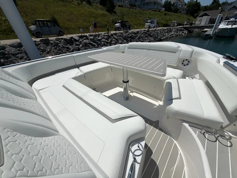 Slide: The Image of The 2026 Tiara Yachts 48 LS features a luxurious seating area with a sleek table and white upholstery. - 7