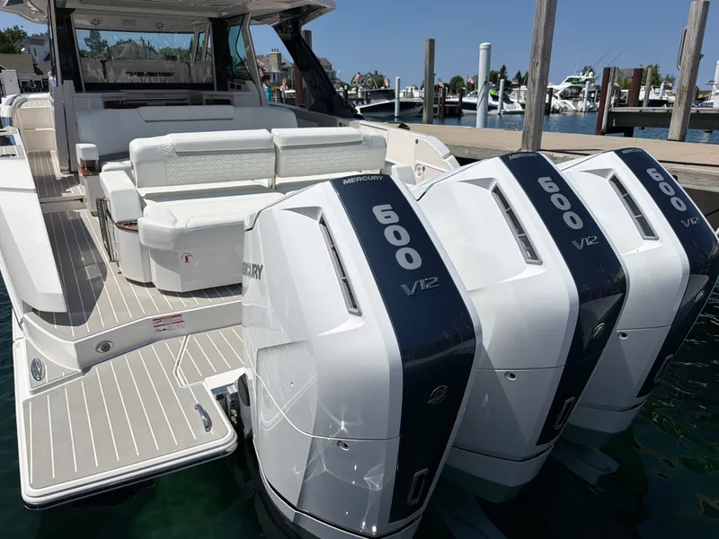 Slide: The Image of The image shows the stern of a 2026 Tiara Yachts 48 LS with three Mercury 600 V12 engines. - 42