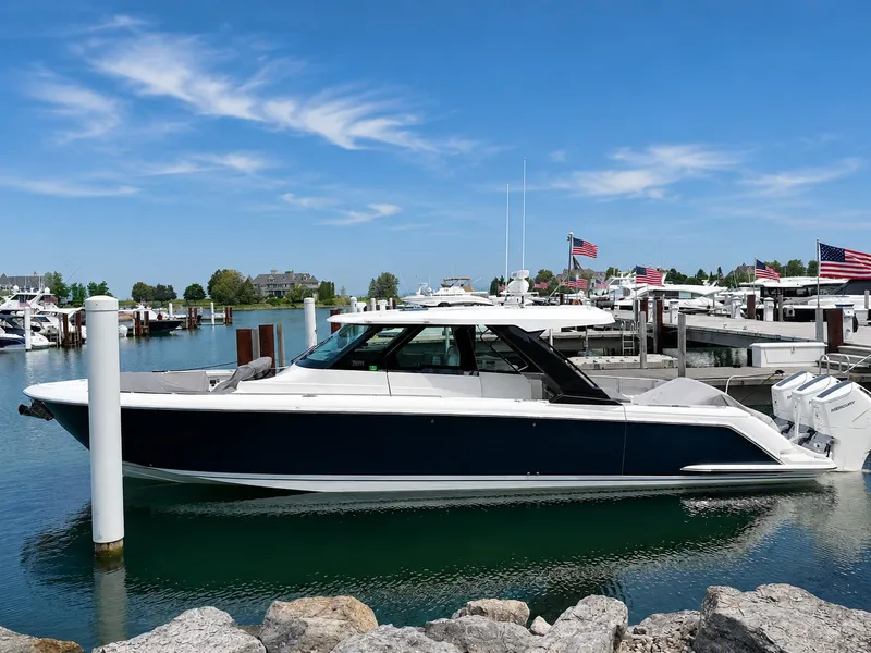 The Image of 2026 Tiara Yachts 48 LS docked, sleek design, blue and white paint, calm waters. - 0