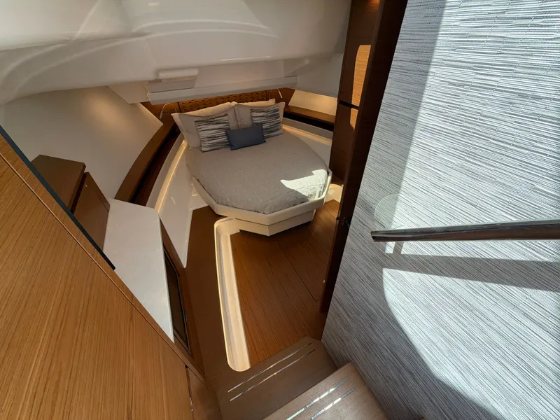Slide: The Image of The 2026 Tiara Yachts 48 LS cabin features a sleek bed and modern wood paneling. - 31