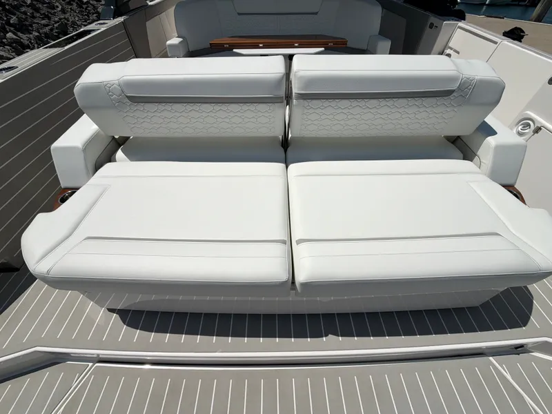 Slide: The Image of The 2026 Tiara Yachts 48 LS features luxurious white upholstery on the deck. - 22