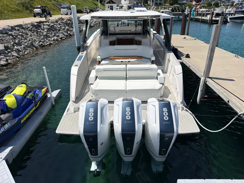 Slide: The Image of A luxurious 2026 Tiara Yachts 48 LS docked. It features three powerful outboard engines. - 41