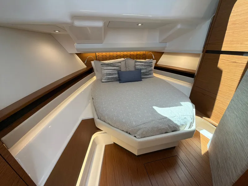 Slide: The Image of The image shows a luxurious cabin with a large bed, wood flooring, and modern accents. - 32