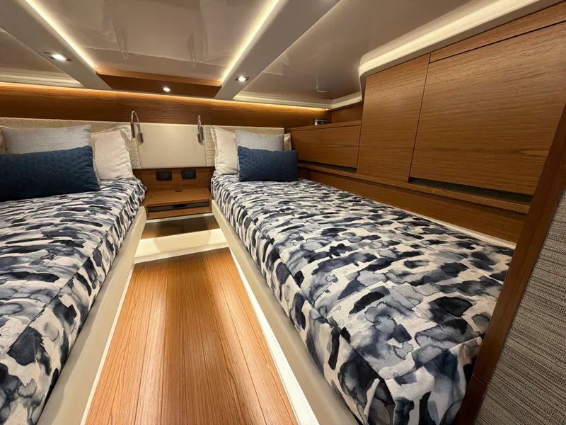 Slide: The Image of The 2026 Tiara Yachts 48 LS cabin features two single beds with patterned covers. - 36