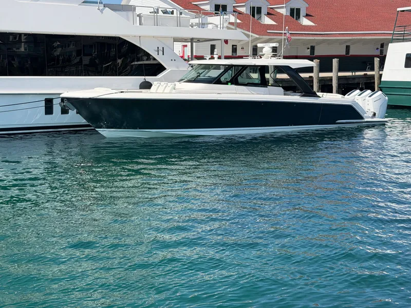 Slide: The Image of A 2026 Tiara Yachts 48 LS is docked in the water beside a pier. - 45