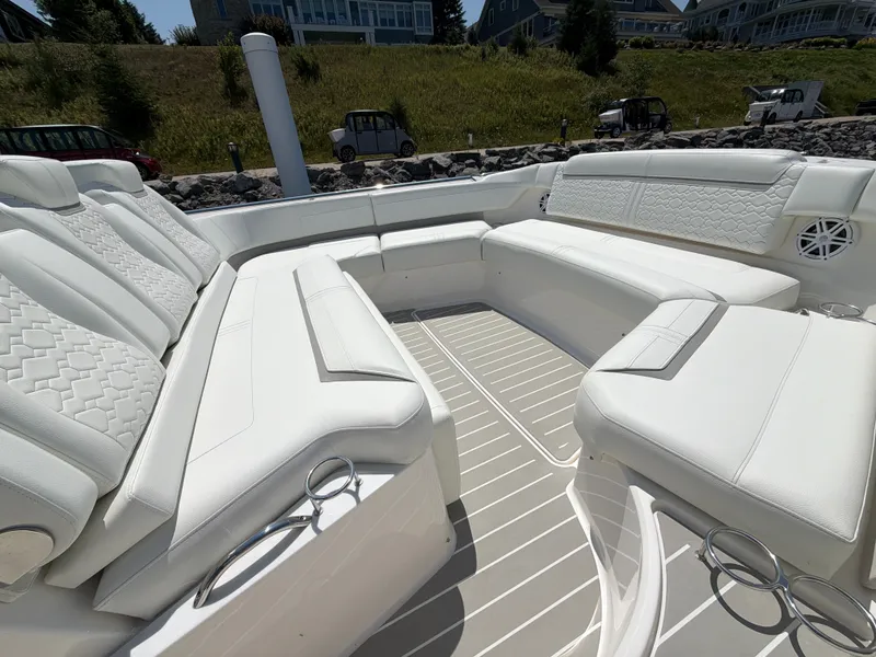 Slide: The Image of The image shows the spacious cockpit of a 2026 Tiara Yachts 48 LS with luxurious white seating. - 3