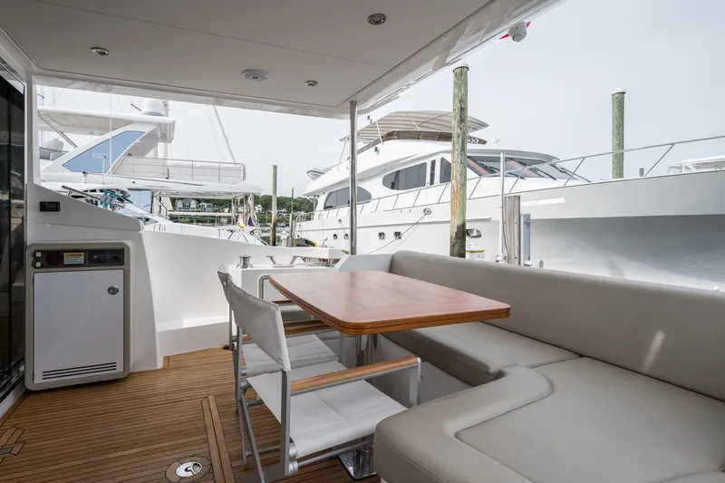 Slide: The Image of 2020 Azimut Fly 50 yacht deck with seating and table, docked at marina. - 26