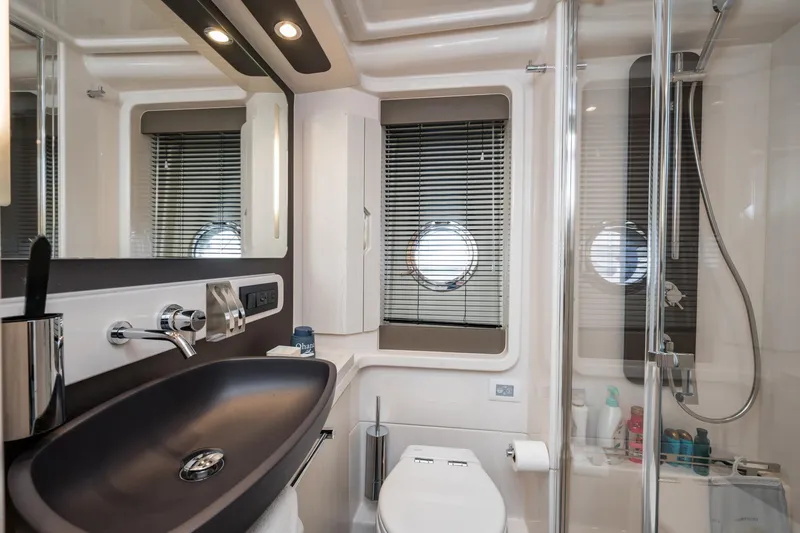 Slide: The Image of Luxurious bathroom in 2020 Azimut Fly 50 yacht with modern fixtures and porthole window. - 62