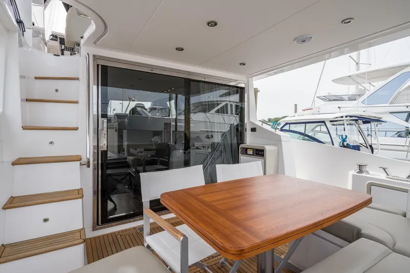 Slide: The Image of Azimut Fly 50 yacht deck with wooden table and seating, 2020 model. - 28