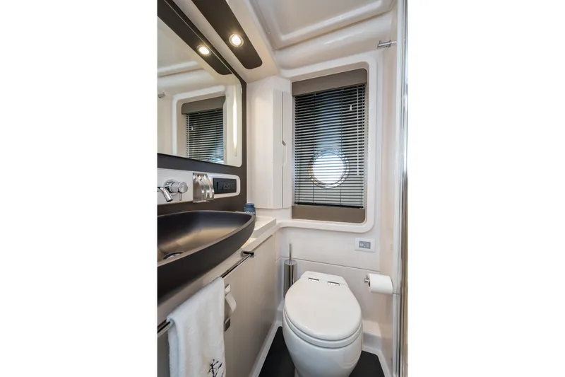 Slide: The Image of Luxurious bathroom in 2020 Azimut Fly 50 yacht with modern fixtures and porthole window. - 61