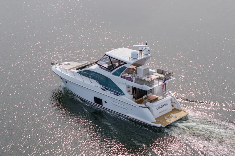 Slide: The Image of 2020 Azimut Fly 50 yacht cruising on sparkling water, rear view. - 11