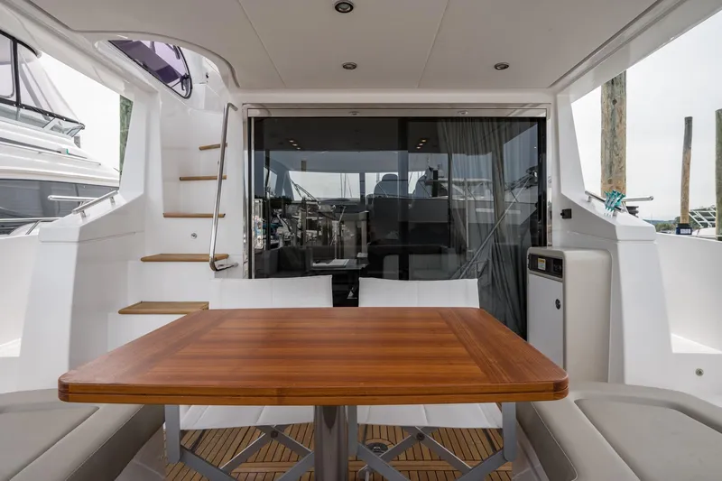 Slide: The Image of Azimut Fly 50 yacht interior, featuring a wooden table and modern design, 2020 model. - 24