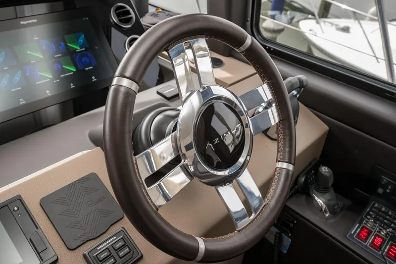 Slide: The Image of Steering wheel and dashboard of 2020 Azimut Fly 50 yacht, featuring modern controls. - 52