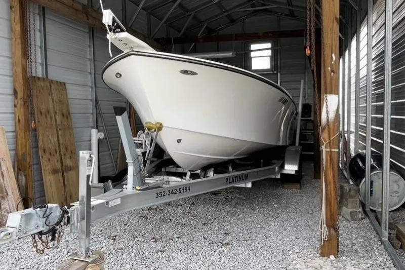 Slide: The Image of 2022 May-Craft 2000 CC boat on trailer in a metal storage shed. - 21