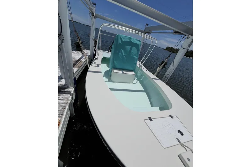Slide: The Image of 2022 May-Craft 2000 CC boat docked, featuring a sleek design and covered seating. - 1