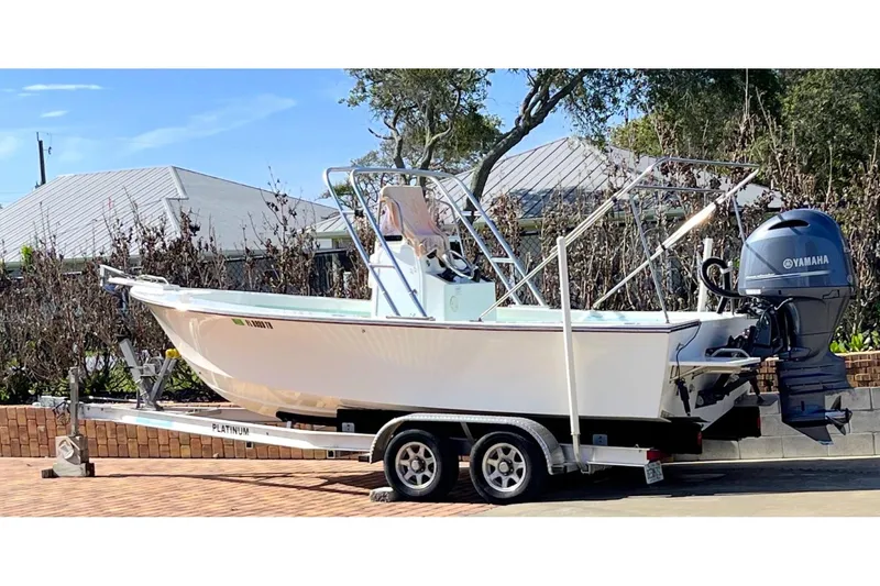 Slide: The Image of 2022 May-Craft 2000 CC boat on trailer with Yamaha outboard motor, parked outdoors. - 0