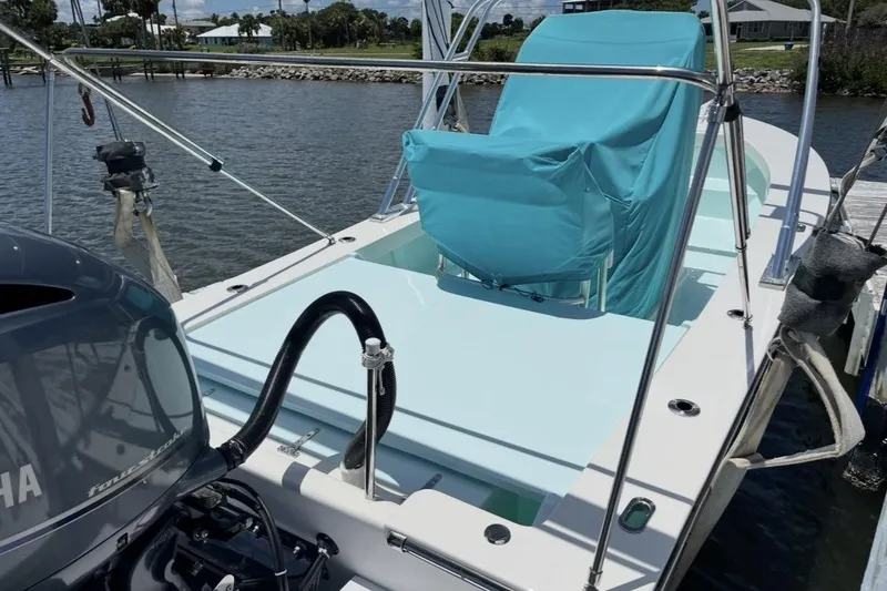 Slide: The Image of 2022 May-Craft 2000 CC boat docked, featuring a covered seat and Yamaha outboard motor. - 4