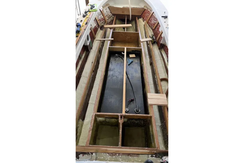 Slide: The Image of Interior view of a 2022 May-Craft 2000 CC boat under construction, showcasing framework details. - 13
