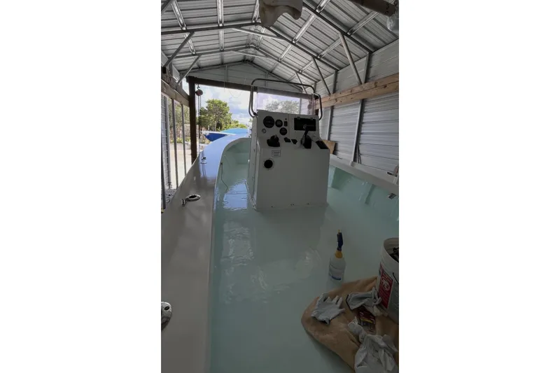 Slide: The Image of 2022 May-Craft 2000 CC boat in a metal shed, interior view. - 18