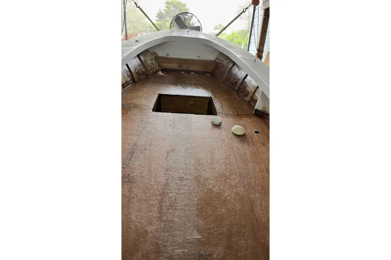 Slide: The Image of 2022 May-Craft 2000 CC boat interior under construction, featuring unfinished deck and open hatch. - 17
