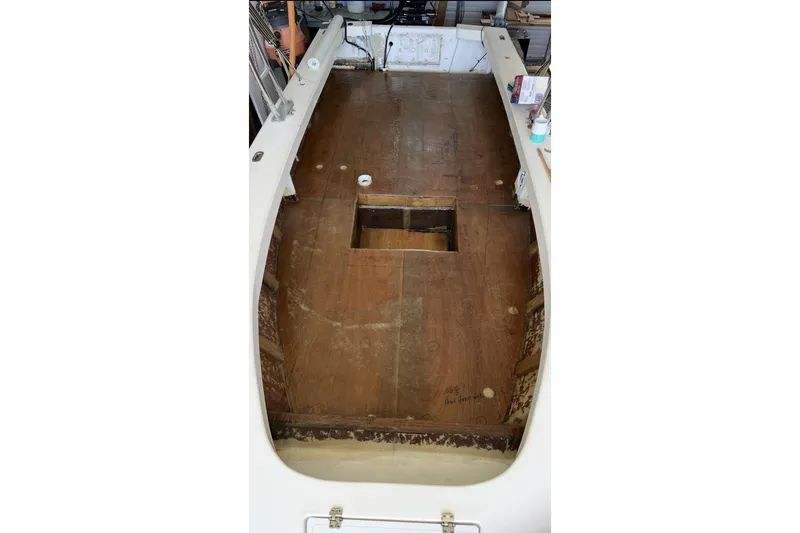 Slide: The Image of 2022 May-Craft 2000 CC boat interior with unfinished wooden deck. - 16