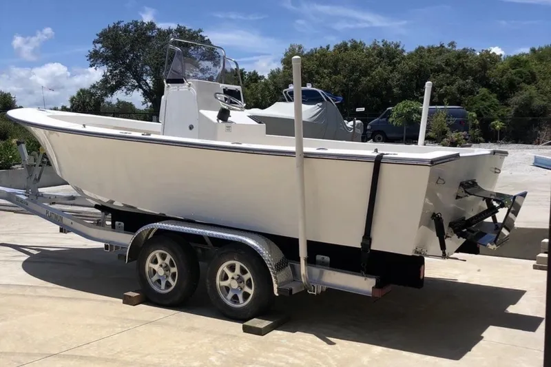 Slide: The Image of 2022 May-Craft 2000 CC boat on trailer, parked outdoors under clear sky. - 19
