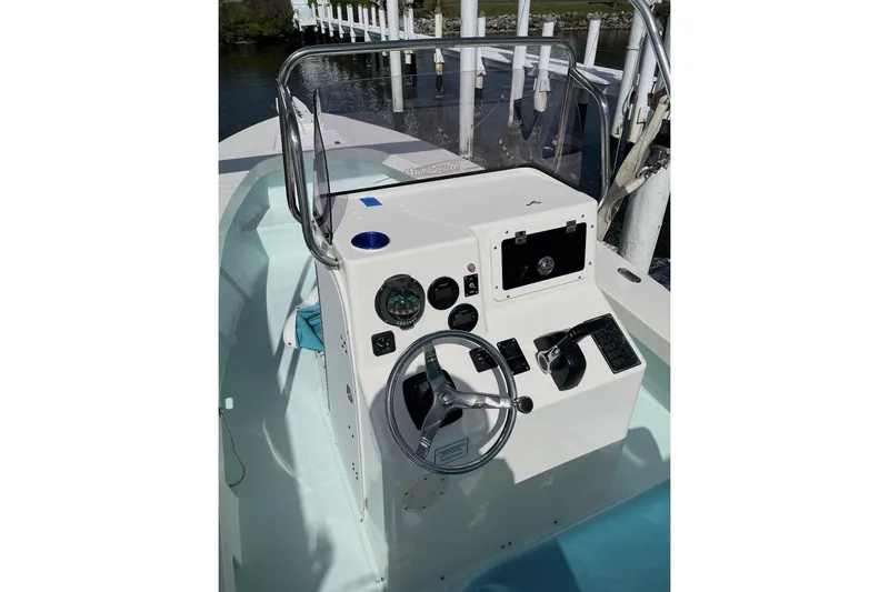 Slide: The Image of 2022 May-Craft 2000 CC boat console with steering wheel and controls. - 6