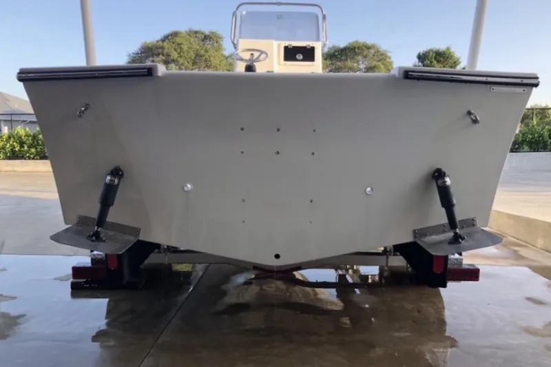 Slide: The Image of 2022 May-Craft 2000 CC boat rear view, showcasing trim tabs and hull design. - 9