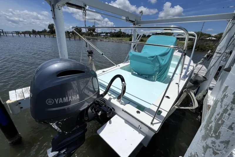 Slide: The Image of 2022 May-Craft 2000 CC boat with Yamaha motor docked by the water. - 3