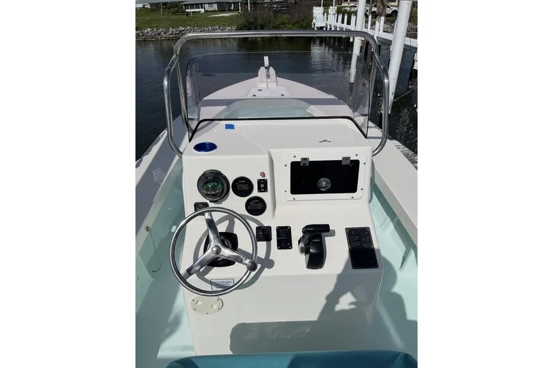 Slide: The Image of 2022 May-Craft 2000 CC boat console with steering wheel and controls. - 7