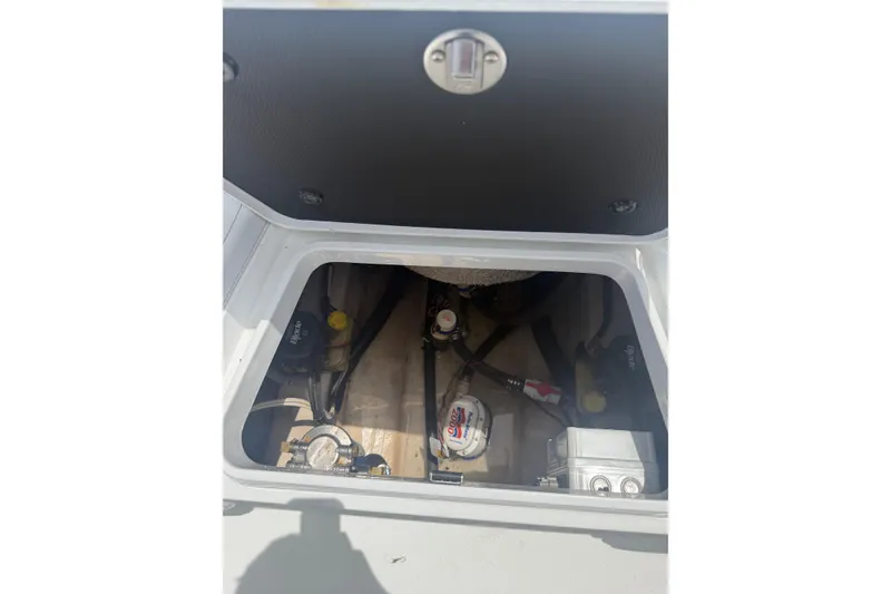 Slide: The Image of 2019 Yellowfin 21 Bay boat compartment with visible mechanical components. - 20