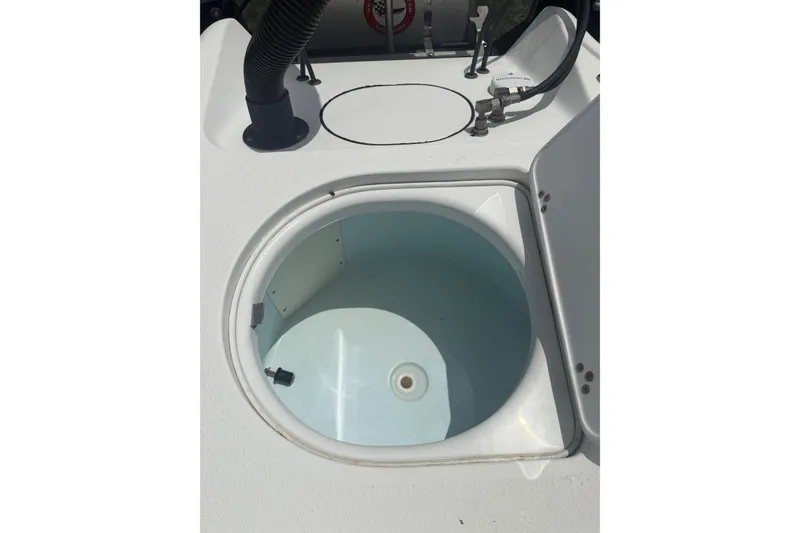 Slide: The Image of 2019 Yellowfin 21 Bay boat livewell with open lid and plumbing details. - 22