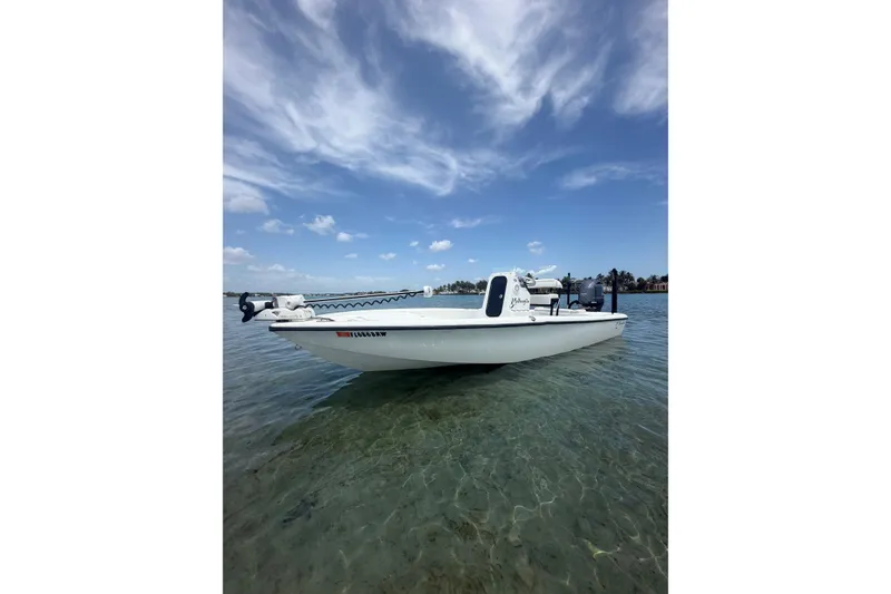 The Image of 2019 Yellowfin 21 Bay boat on clear water under a blue sky. - 0