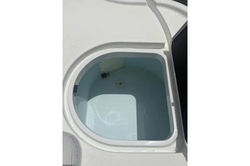 Slide: The Image of 2019 Yellowfin 21 Bay boat livewell, open and empty, showcasing interior design. - 23