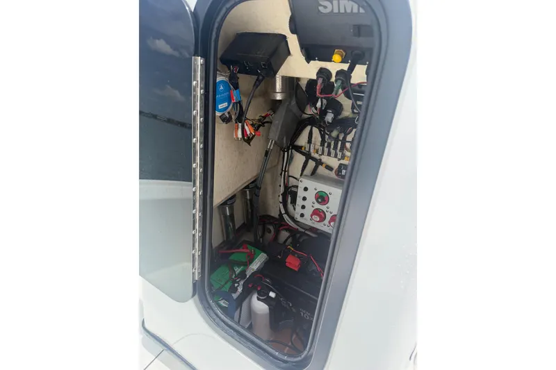 Slide: The Image of 2019 Yellowfin 21 Bay boat electrical compartment with wiring and equipment. - 16