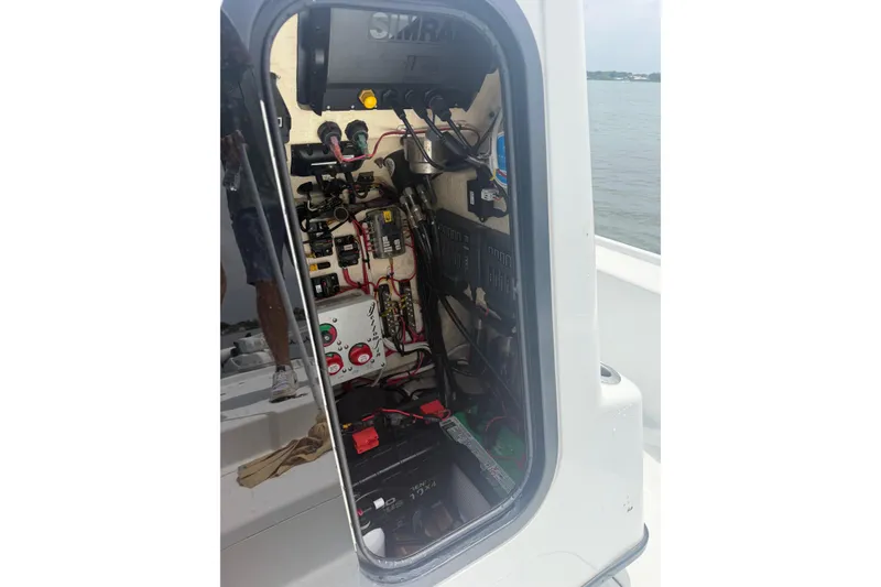 Slide: The Image of Electrical panel inside a 2019 Yellowfin 21 Bay boat, showcasing wiring and components. - 17