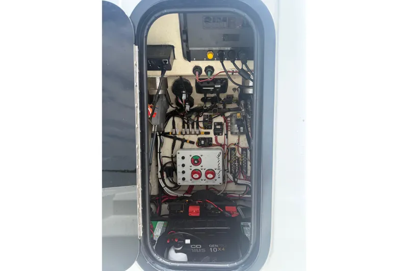 Slide: The Image of Electrical panel inside a 2019 Yellowfin 21 Bay boat, showcasing wiring and components. - 15
