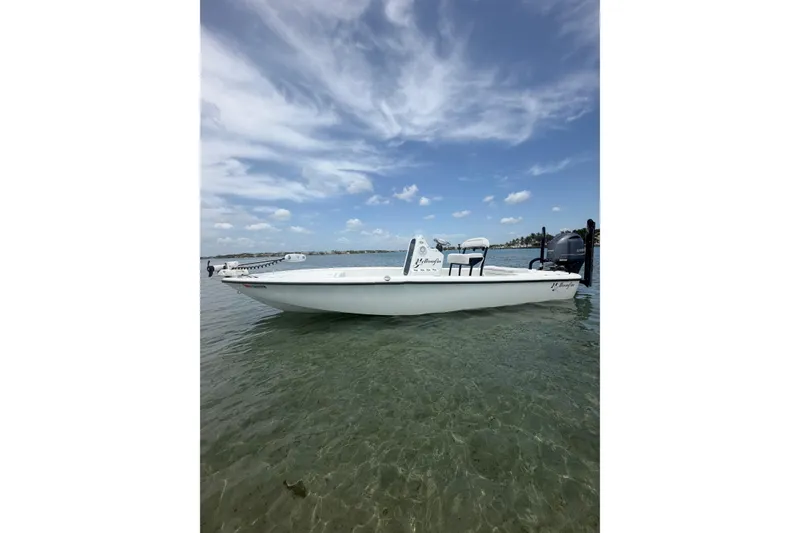 Slide: The Image of 2019 Yellowfin 21 Bay boat on clear water under a partly cloudy sky. - 1
