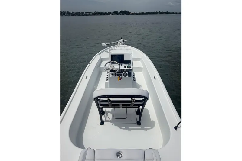 Slide: The Image of 2019 Yellowfin 21 Bay boat interior with steering console on calm water. - 5