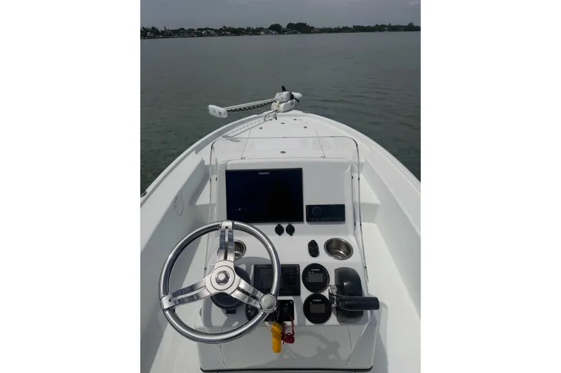 Slide: The Image of 2019 Yellowfin 21 Bay boat dashboard with steering wheel and navigation controls. - 6