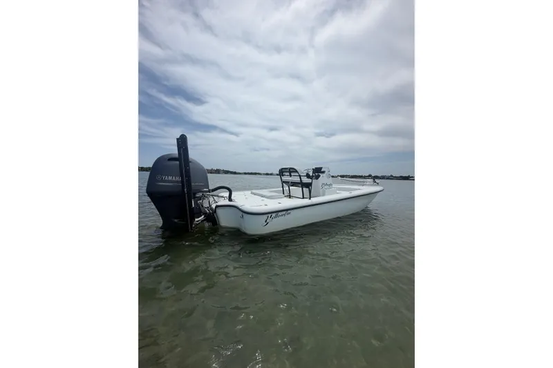 Slide: The Image of 2019 Yellowfin 21 Bay boat with Yamaha engine on calm water under cloudy sky. - 4