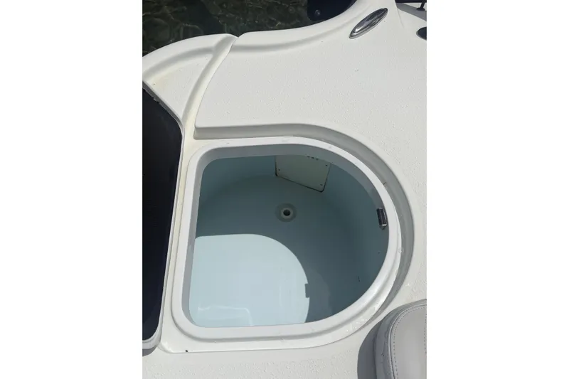 Slide: The Image of Open storage compartment on 2019 Yellowfin 21 Bay boat deck. - 21