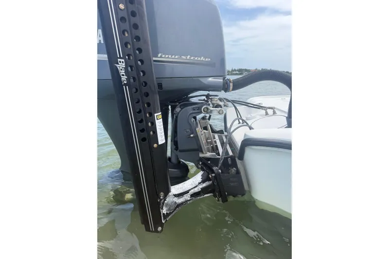 Slide: The Image of 2019 Yellowfin 21 Bay boat engine and power pole in shallow water. - 24