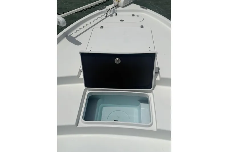 Slide: The Image of 2019 Yellowfin 21 Bay boat with open storage compartment on deck. - 12