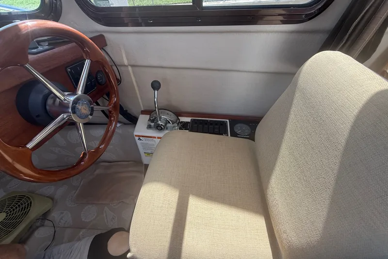 Slide: The Image of Interior of 2012 Ranger Tugs R-21 EC with steering wheel and control panel. - 14