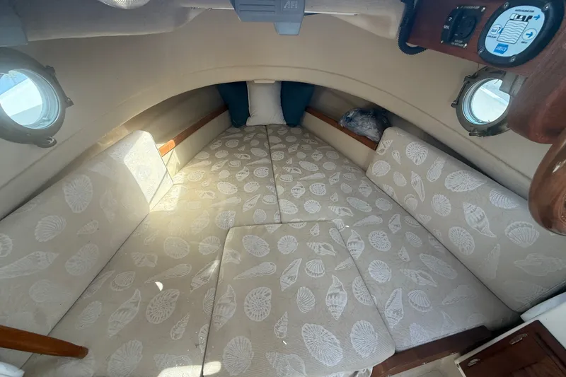 Slide: The Image of Cozy cabin interior of 2012 Ranger Tugs R-21 EC with patterned cushions and portholes. - 21