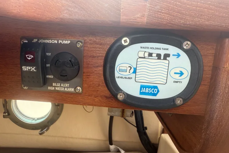 Slide: The Image of Control panel of a 2012 Ranger Tugs R-21 EC with bilge alarm and waste tank indicators. - 35