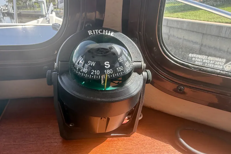 Slide: The Image of Ritchie compass inside a 2012 Ranger Tugs R-21 EC boat, near a window. - 20
